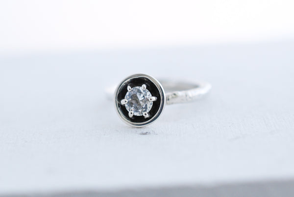 Silver engagement statement ring with white topaz