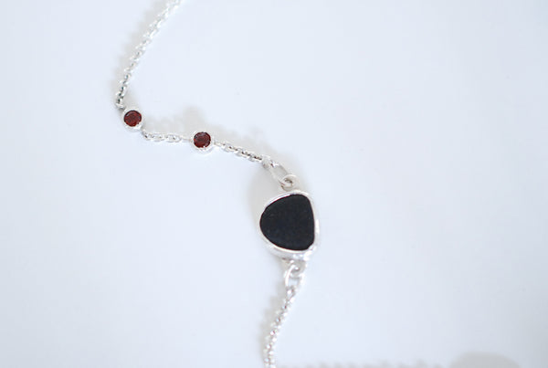 Silver bracelet with natural black stone and red garnets