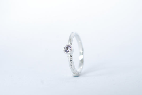 Silver stacking ring with amethyst gemstone.