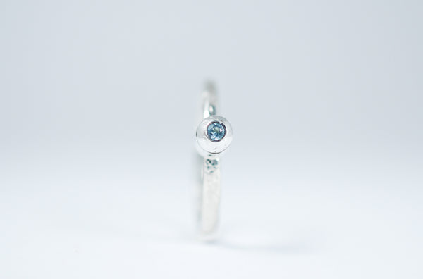 Silver stacking ring with blue Topaz.