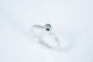 Silver stacking ring with blue Topaz.