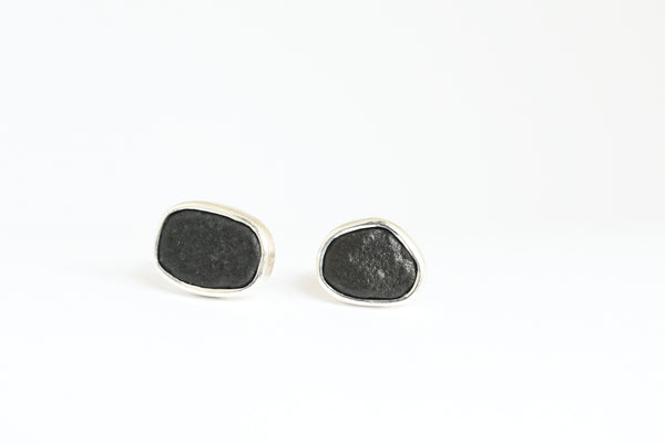 Black beach stone set in silver bezel. Handmade stud earrings