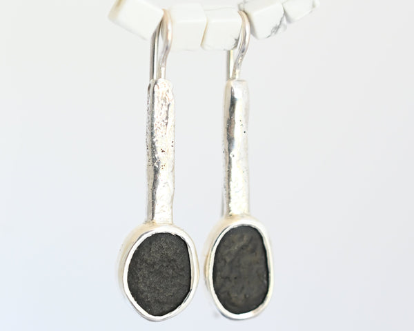 Handmade silver earrings with black seashore pebble stone and rough surface