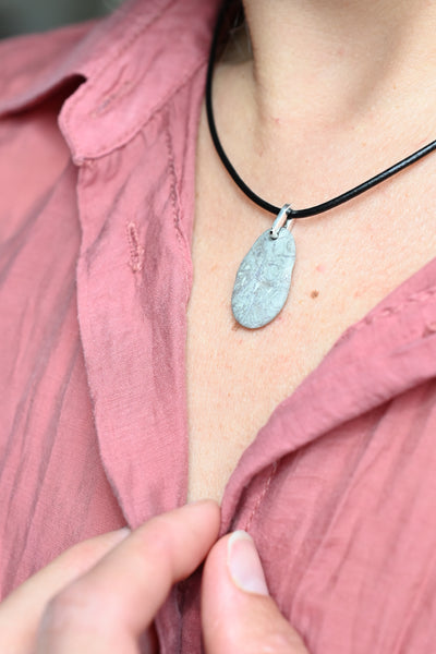 grey pendant on a black cord. summer necklace