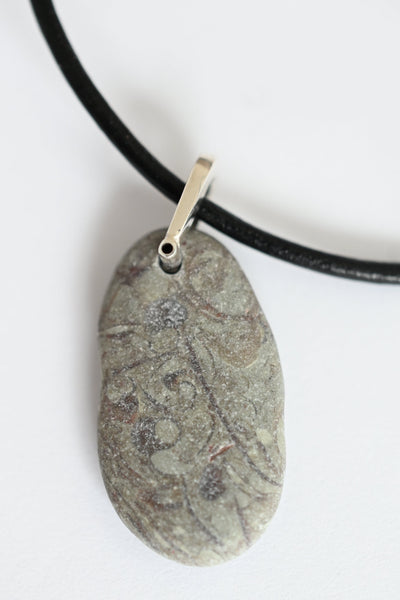 Pebble-shaped pendant on a black cord 