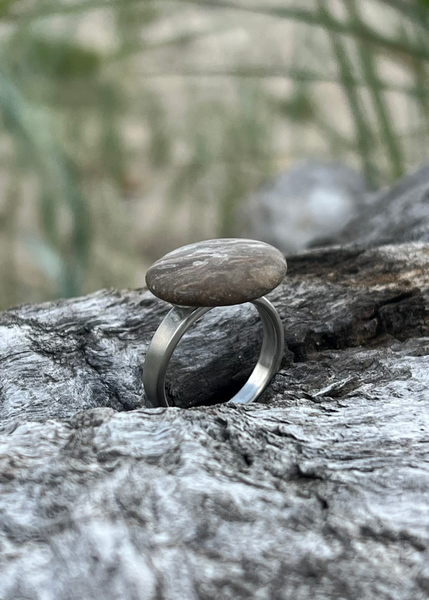 Handcrafted authentic Silver ring with a stone on a wooden surface