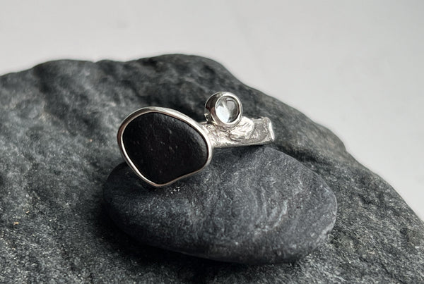 Silver ring with a black stone and blue topaz. Inspired by nature
