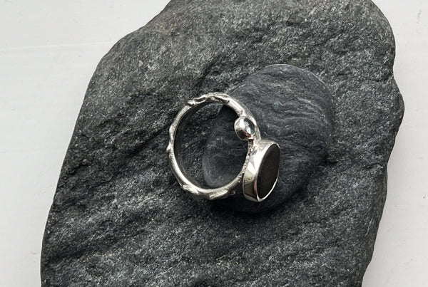 Silver ring with a black stone and blue topaz. Inspired by nature