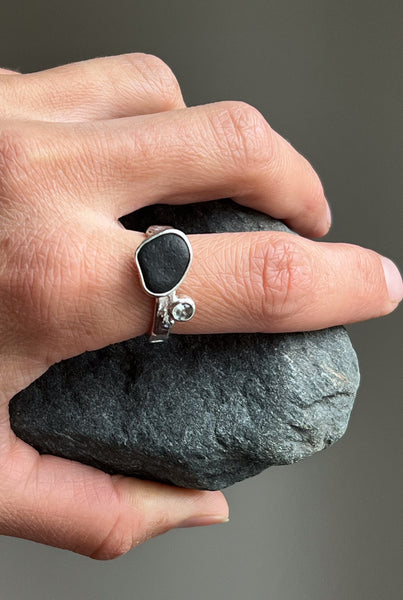 Silver ring with a black stone and blue topaz. Inspired by nature