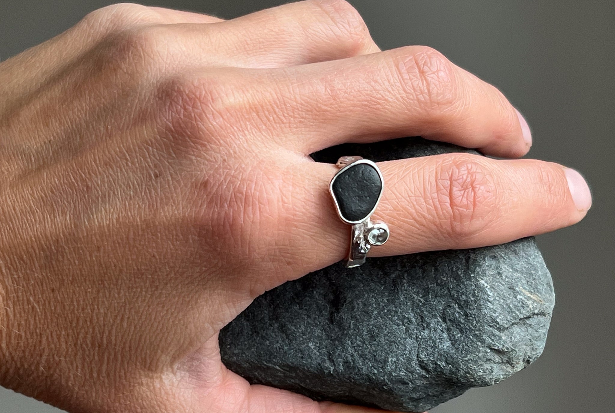 Silver ring with a black stone and blue topaz. Inspired by nature