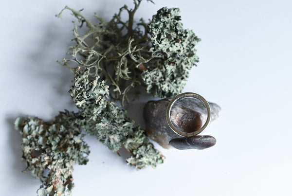 Handmade silver ring with a beach oval-shaped pebble in purple and green colours