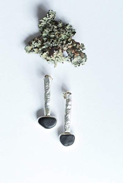 Dangling beach pebble silver earrings. Black stone jewellery.