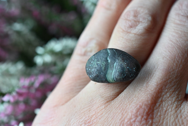 Handmade silver ring with a beach oval-shaped pebble in purple and green colours