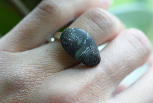 Handmade silver ring with a beach oval-shaped pebble in purple and green colours