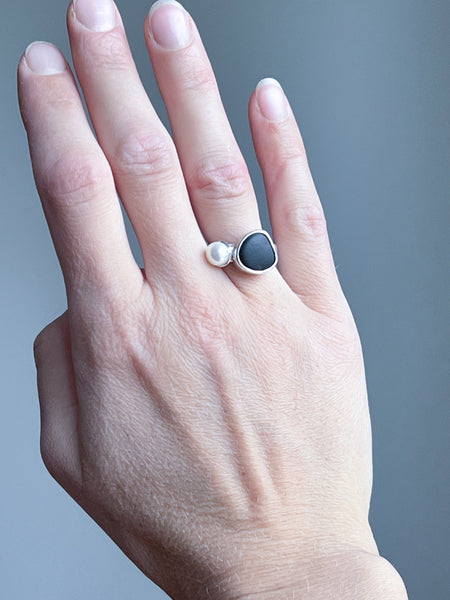 Black beach pebble and white pearl statement ring. Handmade silver jewellery.