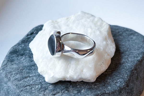 Black beach pebble and white pearl statement ring. Handmade silver jewellery.