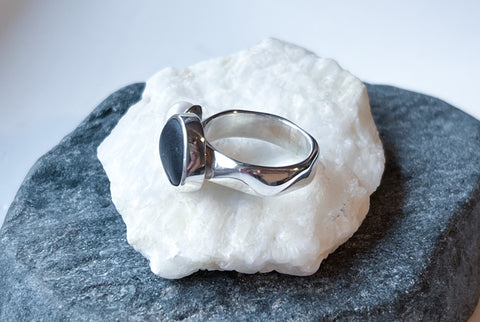 Black beach pebble and white pearl statement ring. Handmade silver jewellery.