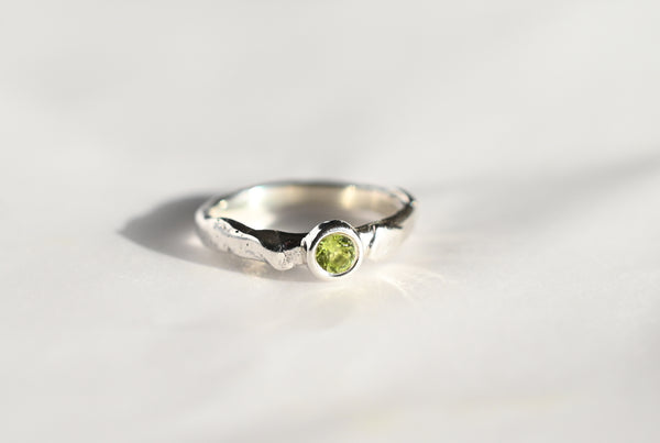 Handmade silver ring with green peridot gemstone. 