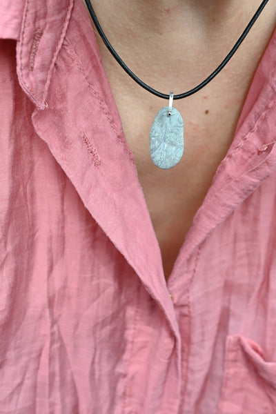 grey seaside pebble stone on black leather cord. Summer vibes