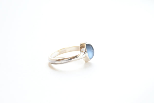 Silver ring with a grey moonstone on a white background