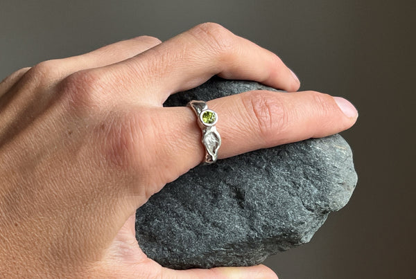 Handmade silver ring with green peridot stone.