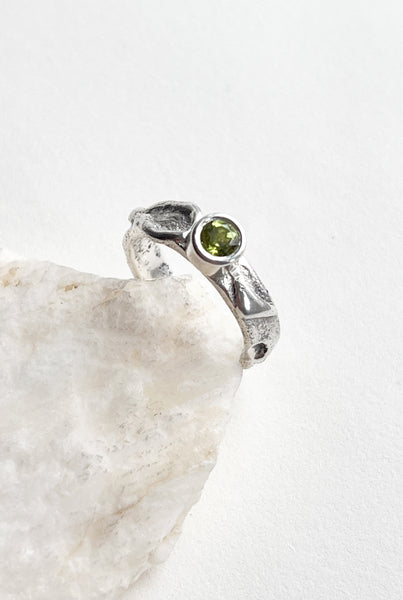 Handmade silver ring with green peridot stone.