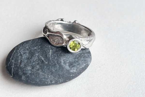 Handmade silver ring with green peridot stone.