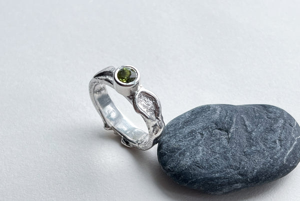 Handmade silver ring with green peridot stone.