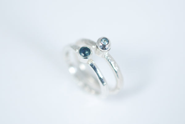 Silver stacking ring with blue Topaz.