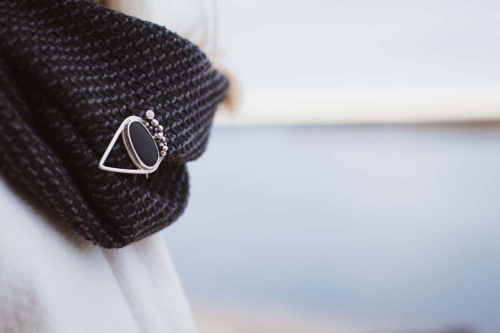 Unique silver brooch with clear white Sapphire and black stone