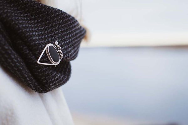 Unique silver brooch with clear white Sapphire and black stone