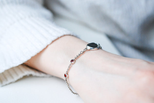 Silver bracelet with natural black stone and red garnets