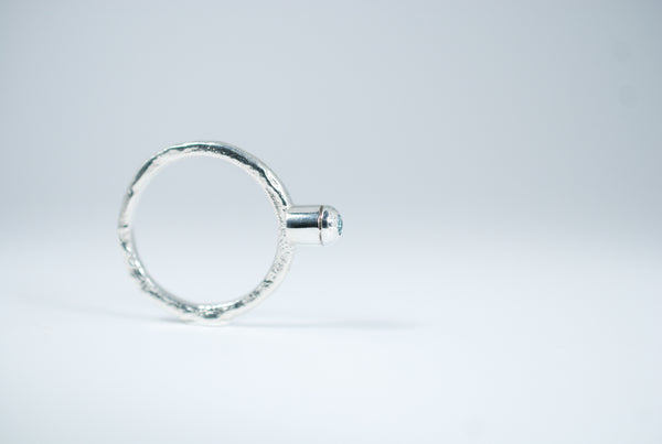 Silver stacking ring with blue Topaz.